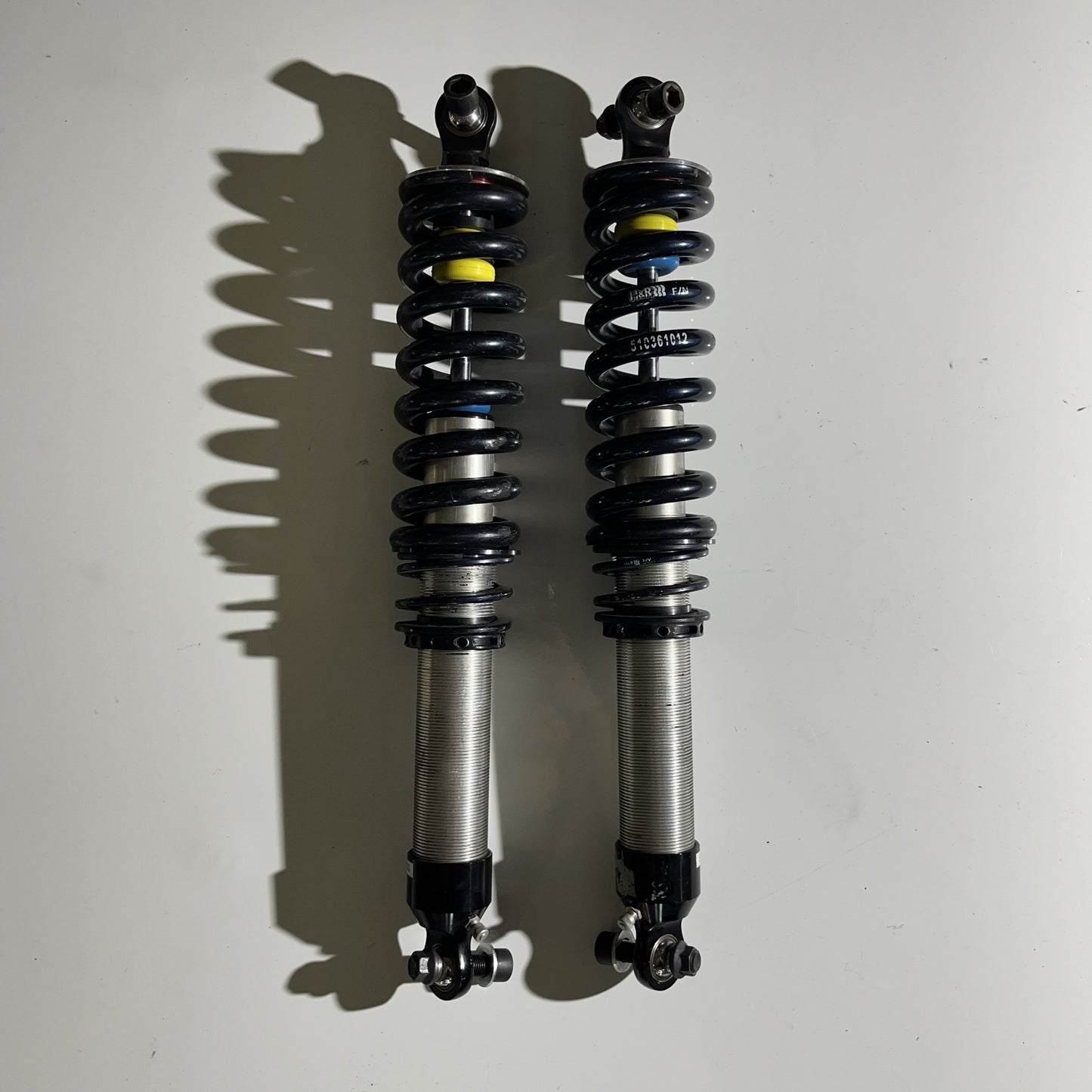 Damper with helper and spring